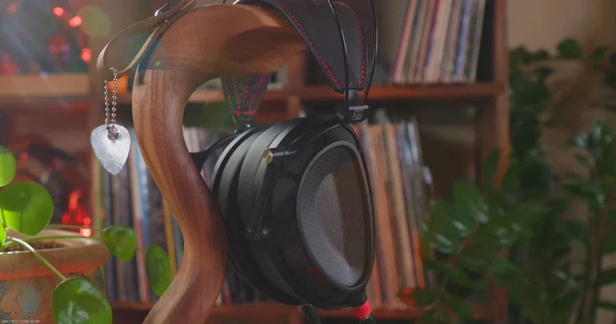 Dan Clark Audio Stealth headphones on wooden stand with records, home audio decor at The Source AV