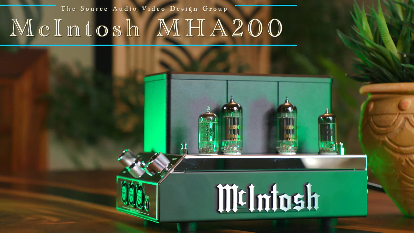 McIntosh MHA200 headphone amplifier with vacuum tubes on a wood table, premium audio equipment